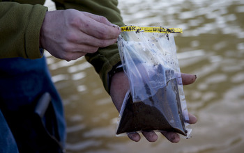 Man holding a sample of dirt in a bag